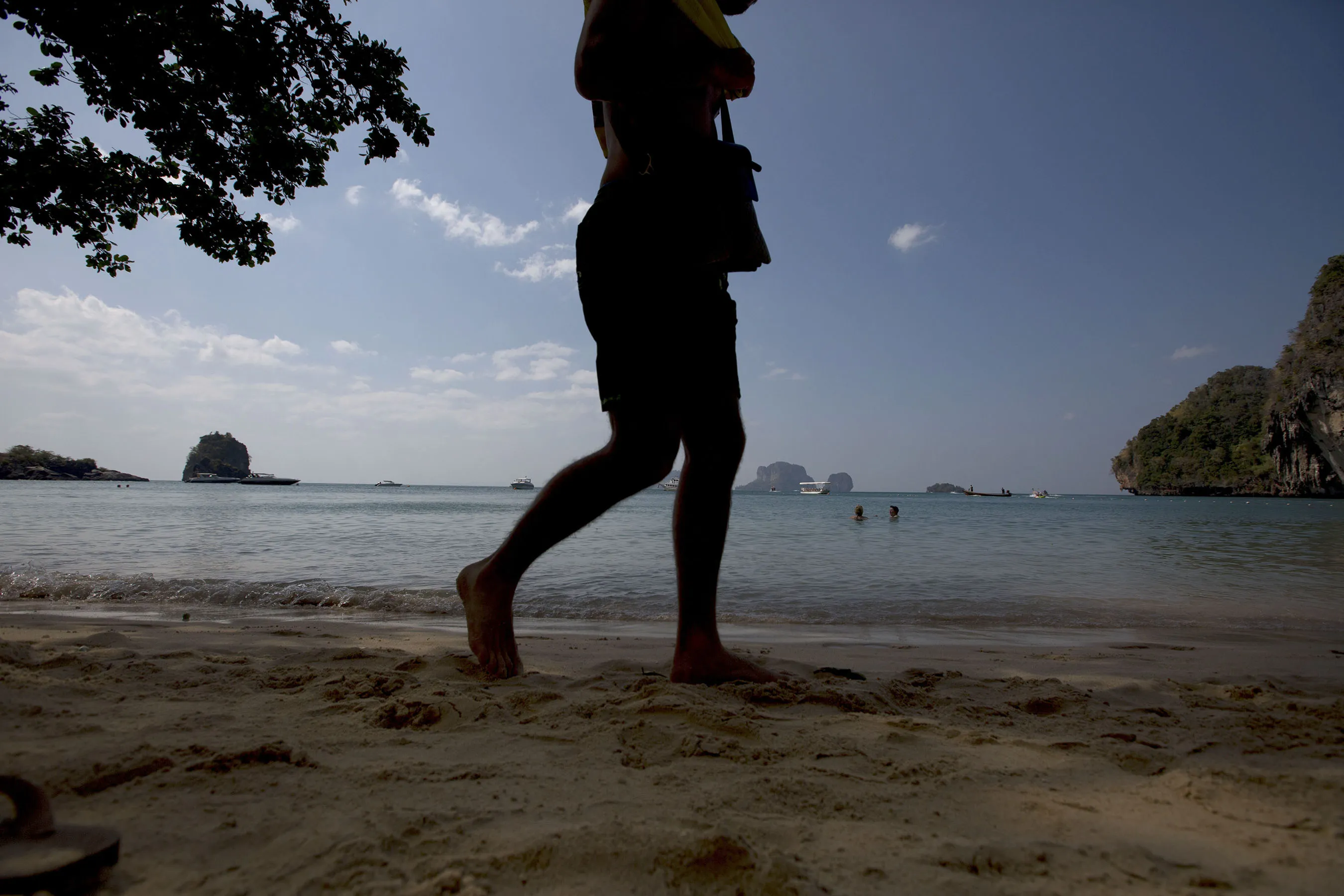 A tourist walks at Railay beach in Krabi, Thailand.
