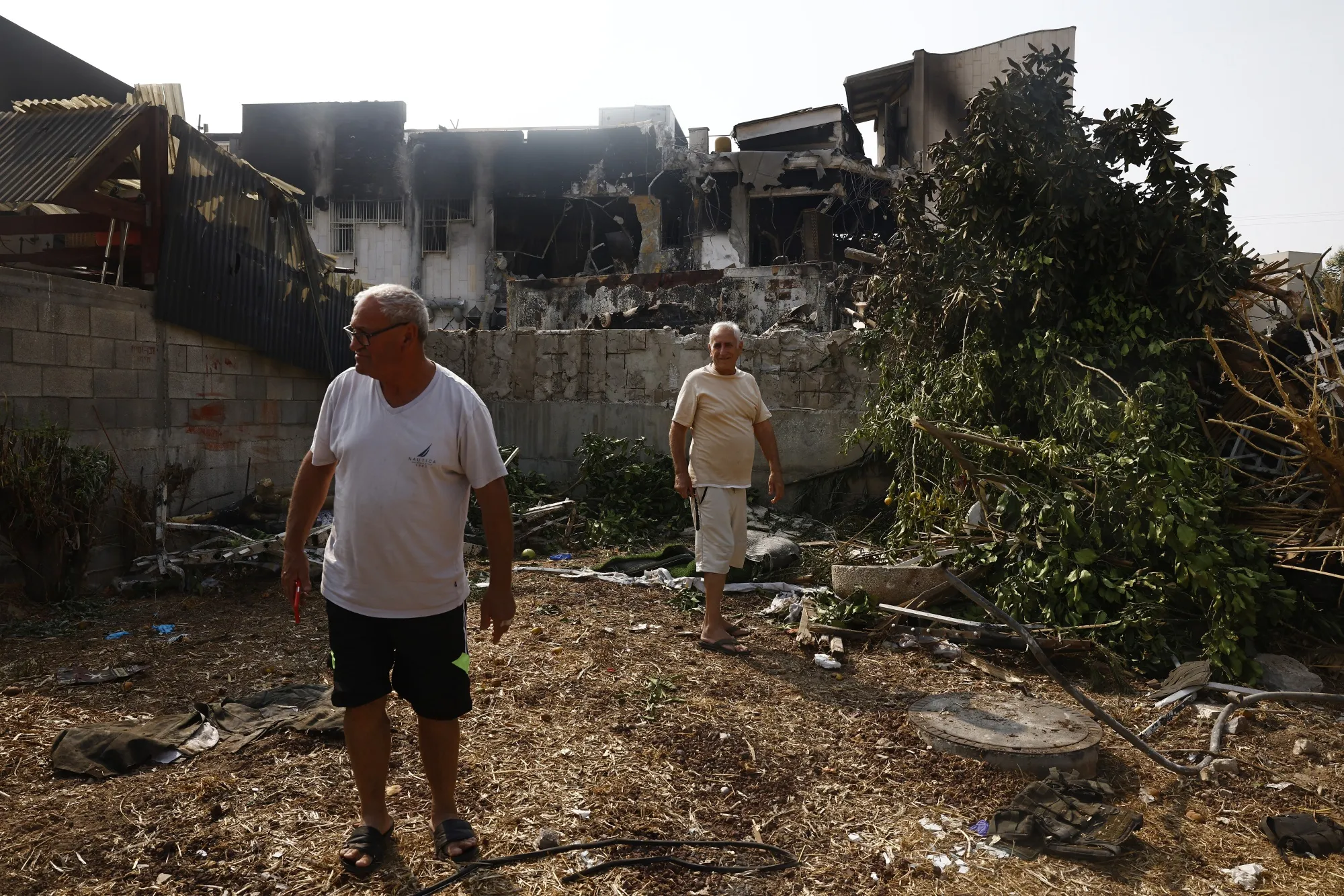 Residents look at the damage to a police station destroyed in Sderot, Israel, on Sunday.