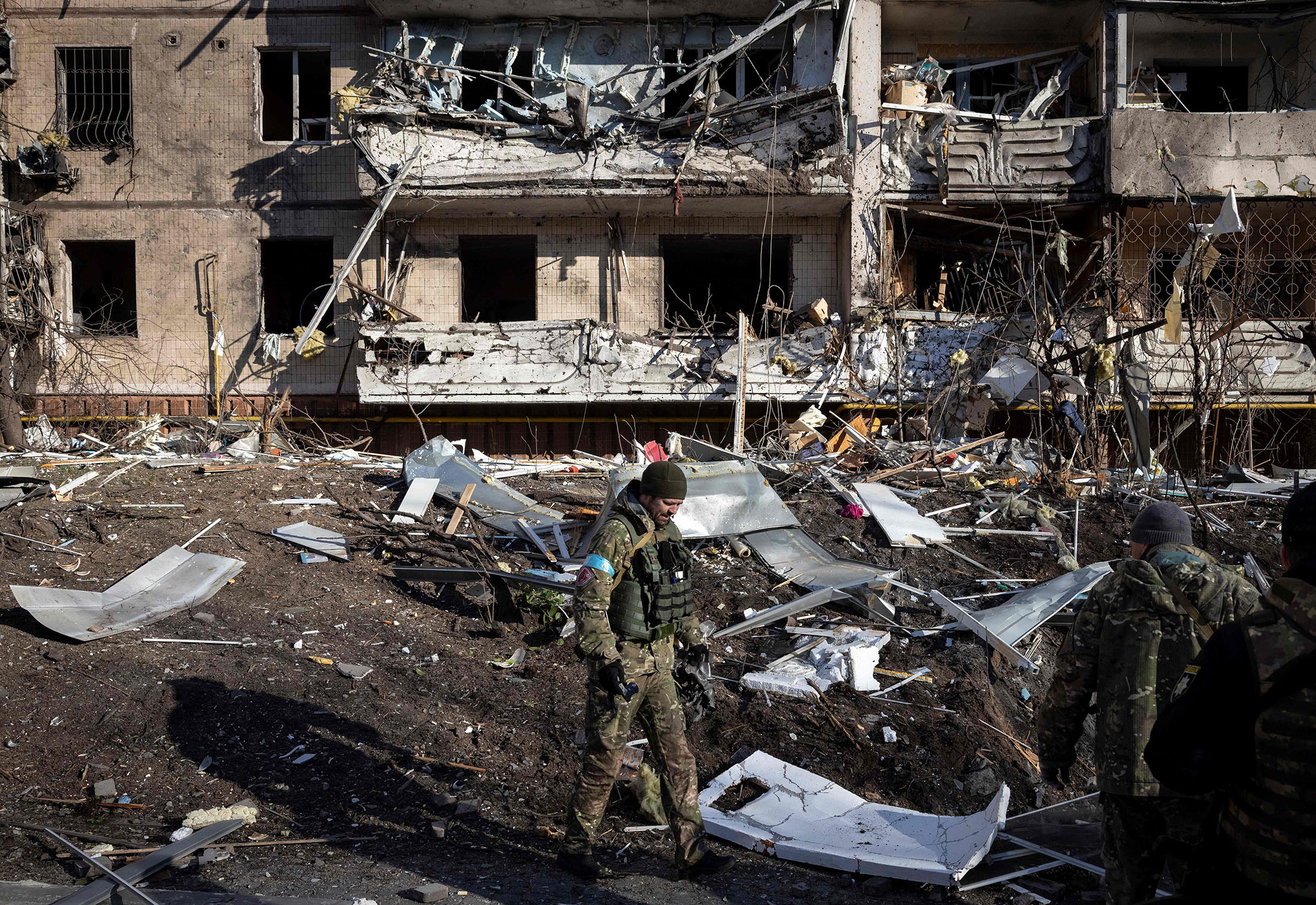 A Ukraine soldier inspects the rubble of a destroyed apartment building in Kyiv on March 15.