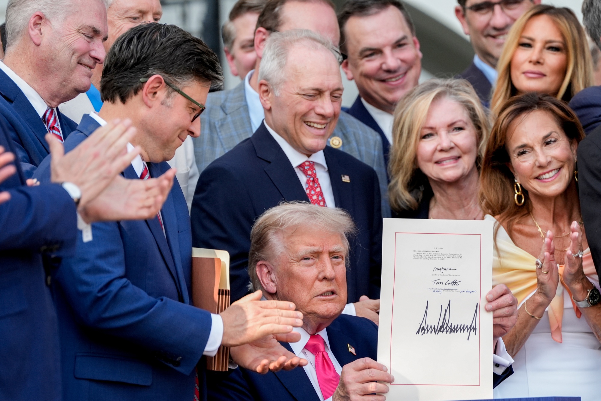 US President Donald Trump displays the signed bill during a ceremony for the One Big Beautiful Bill Act on the South Lawn of the White House in Washington, DC, US, on Friday, July 4, 2025. Trump signed his $3.4 trillion budget bill into law Friday, enshrining an extension of tax cuts, temporary new breaks for tipped workers and funding to crack down on illegal immigration. Photographer: Alex Brandon/AP/Bloomberg