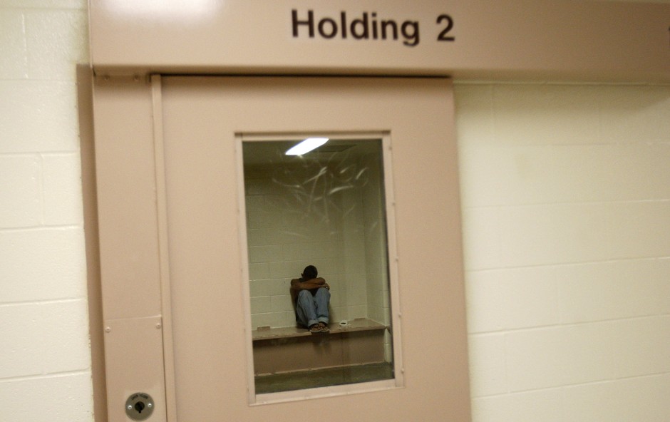 A suspected youth gang member waits to be booked inside the Hidalgo County Sheriff's Adult Detention Center after being arrested for possession of marijuana in Edinburg, Texas.