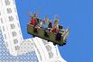 Photo illustration of a family riding down a growing receipt at an amusement park