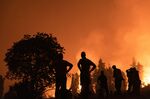 Residents watch over the wildfire outside the village of Kamatriades, on Evia island, Greece, on&nbsp;Aug. 9, 2021.