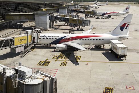 Images Of Malaysian Airlines As Carrier Bans Checked Bags Over Fears Headwinds Could Leave Jets Short on Gas
