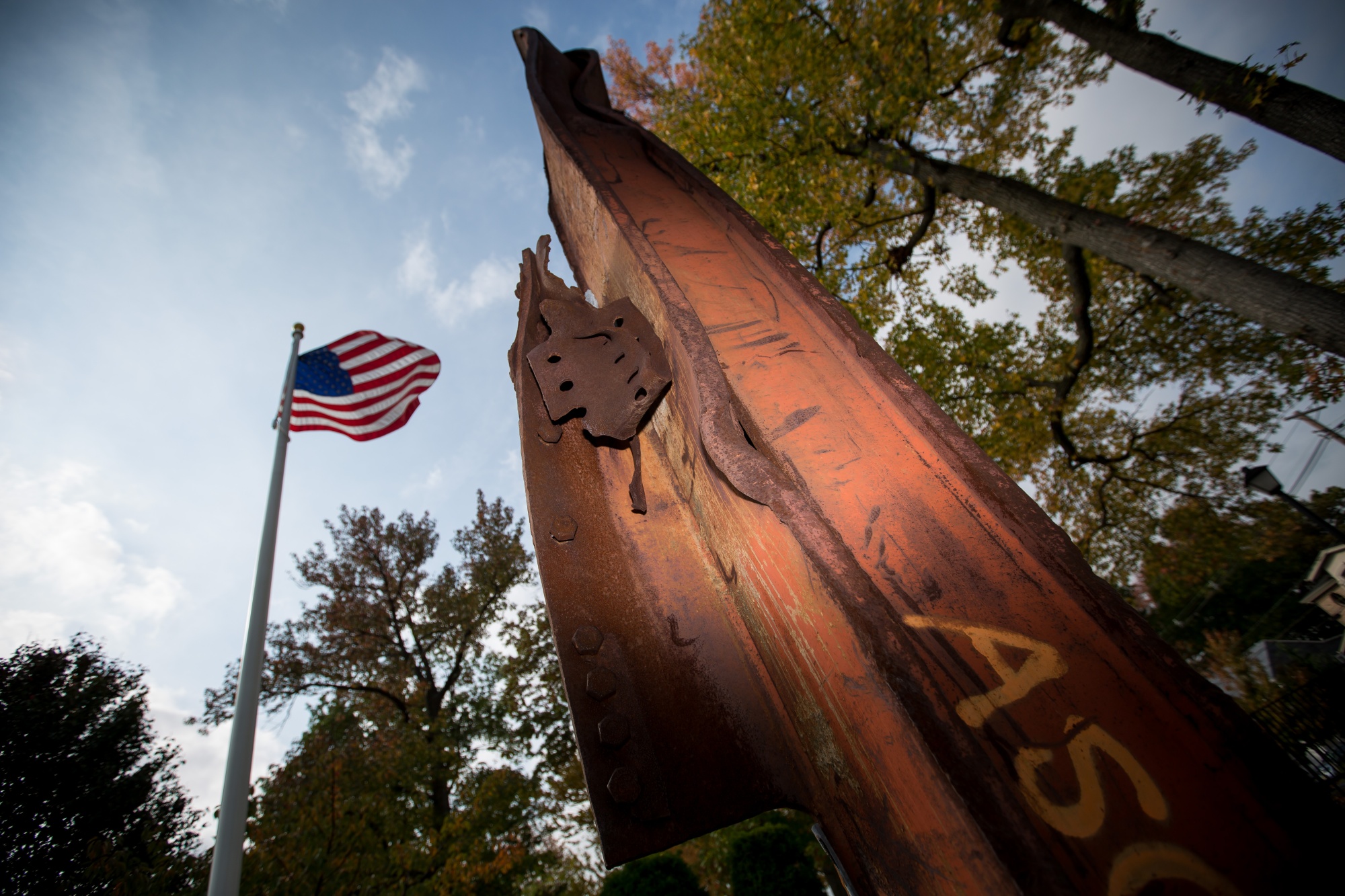 An American flag flies behind steel from the World Trade Center at Constitution Park in Fort Lee, New Jersey —&nbsp;one of many local memorials to the Sept. 11 attacks across the U.S.&nbsp;