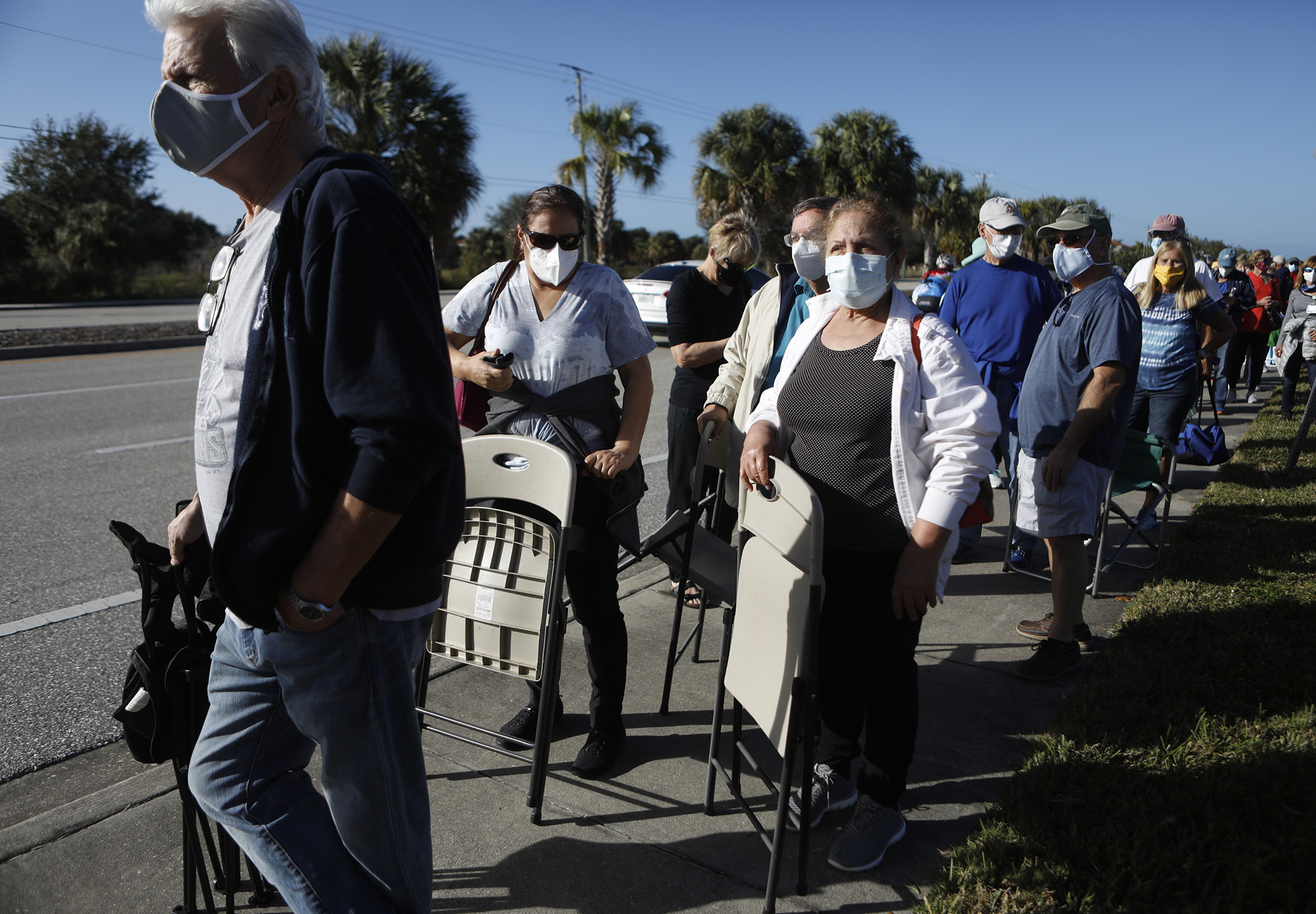 People wait in line to receive a Covid-19 vaccine in Fort Myers, Florida.