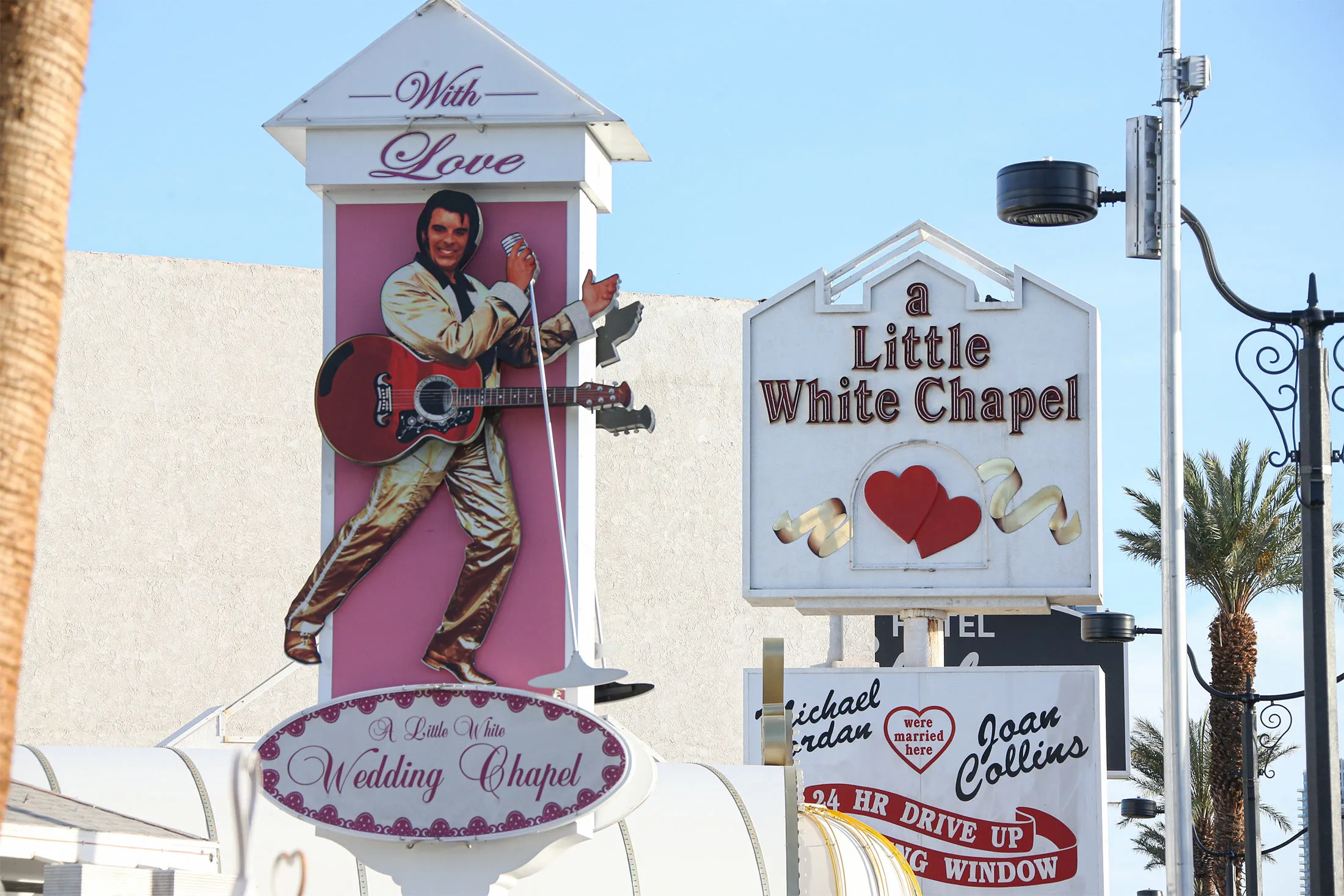 A sign featuring the likeness&nbsp;of Elvis Presley is displayed on a sign in front of the Little White Chapel in Las Vegas, Nevada.