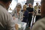 A voter casts her vote at a polling station during the Catalonian parliamentary election in Barcelona, on Sept. 27.
