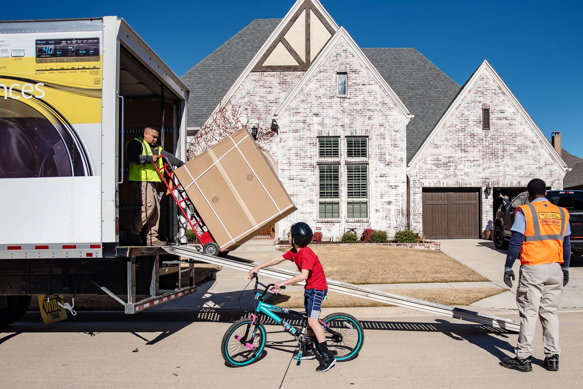 JB Hunt Final Mile workers unload furniture from a truck in Prosper, Texas.