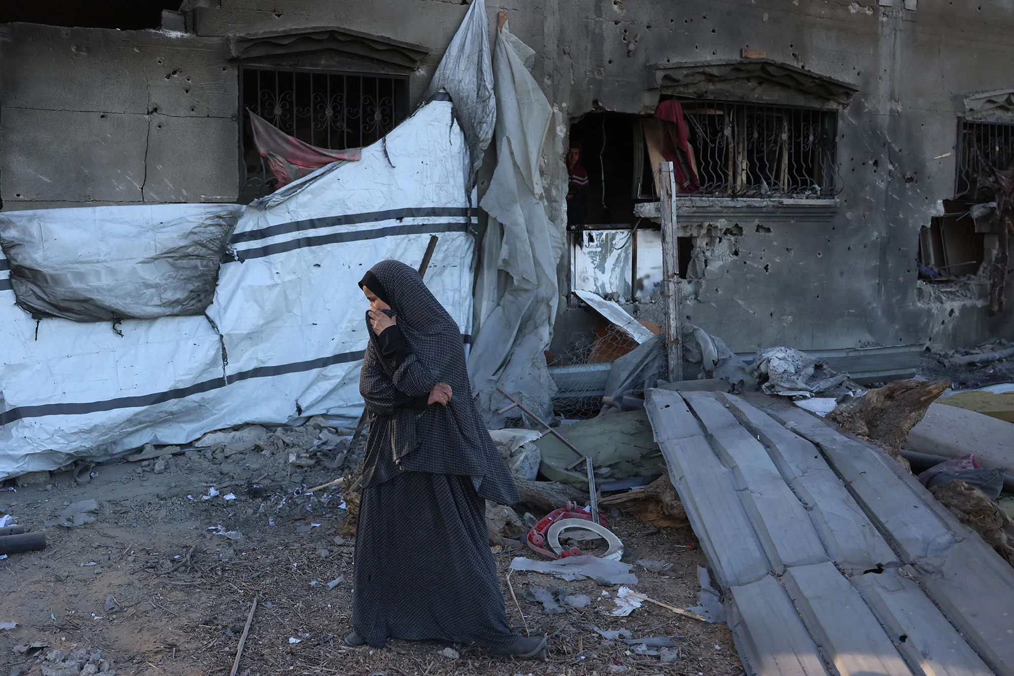 A woman reacts at the site of an Israeli strike&nbsp;in Khan Yunis, Gaza, on Oct. 25.