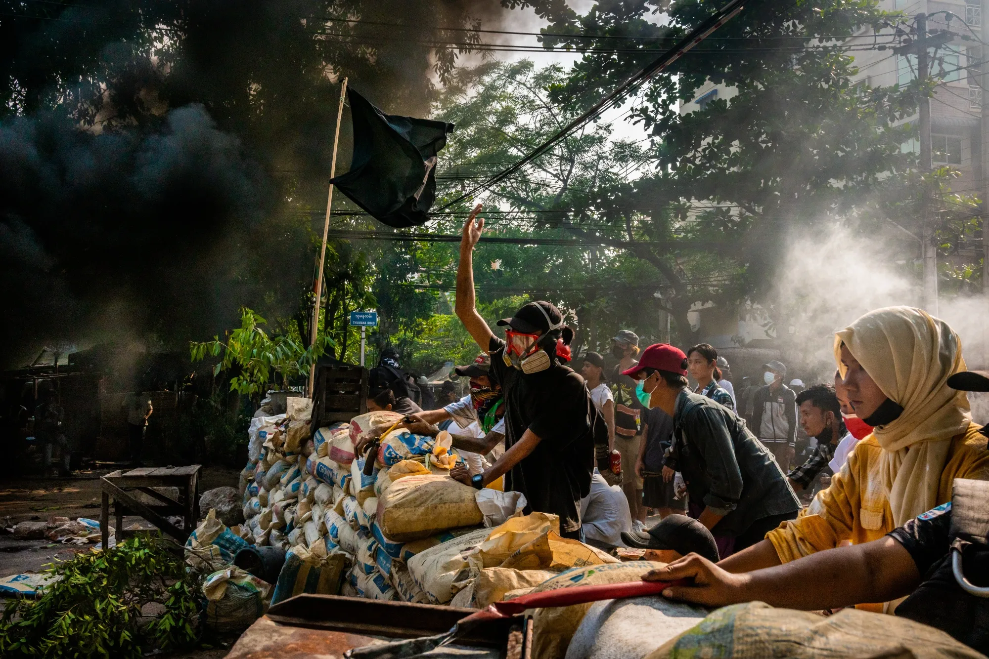 Protesters shout slogans towards approaching security forces in Yangon in March 2021.