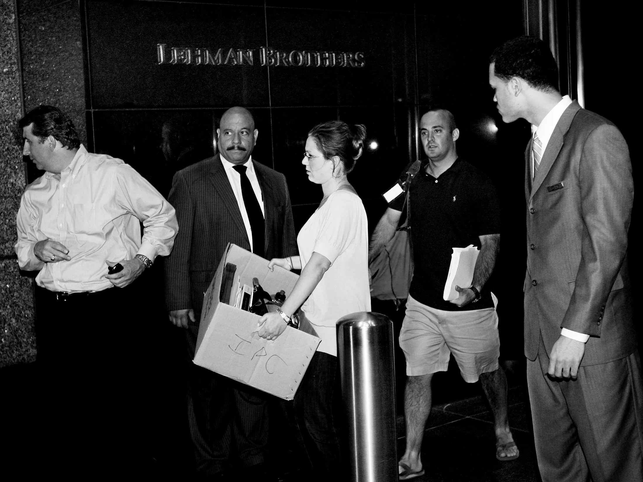 Employees exit Lehman Brothers’ office carrying their belongings on Sept. 14, 2008, in New York.