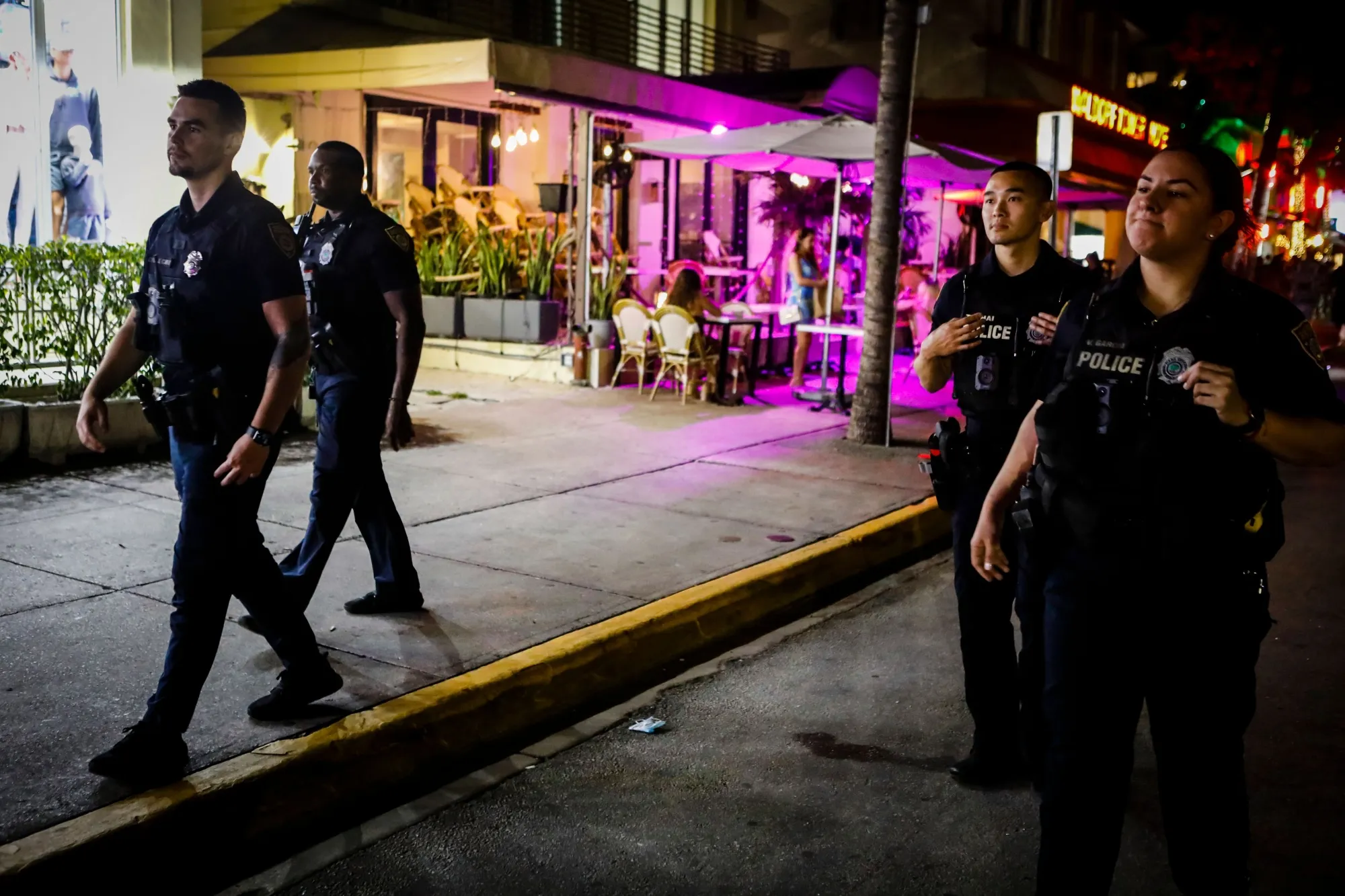 Miami Beach Police patrol Ocean Drive before a curfew goes into effect during Spring Break in 2022.