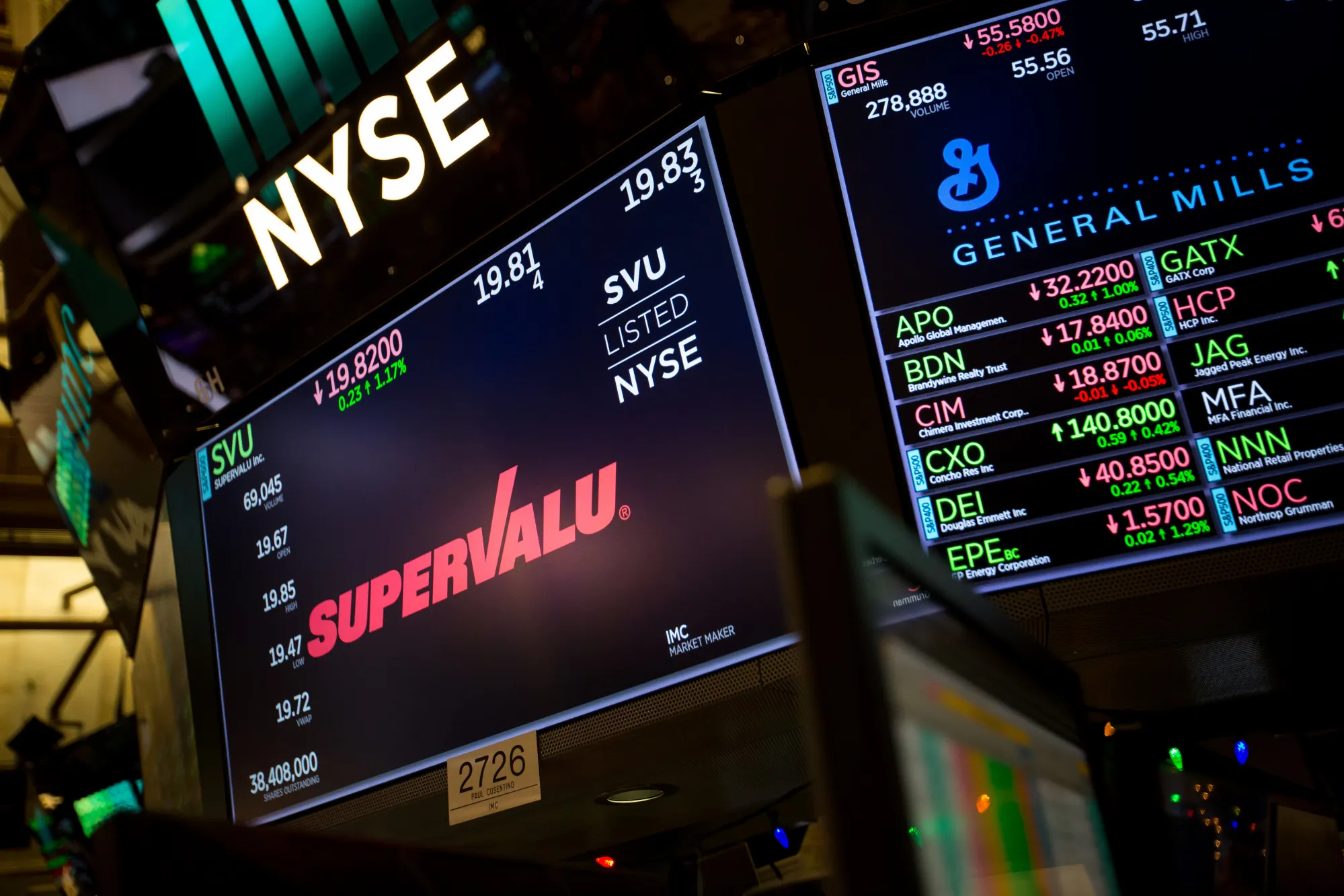 A monitor displays SuperValu Inc. signage on the floor of the New York Stock Exchange (NYSE) in New York, U.S., on Monday, Dec. 11, 2017. U.S. stocks were higher after an explosion rocked midtown Manhattan. The dollar fell and Treasuries rose.