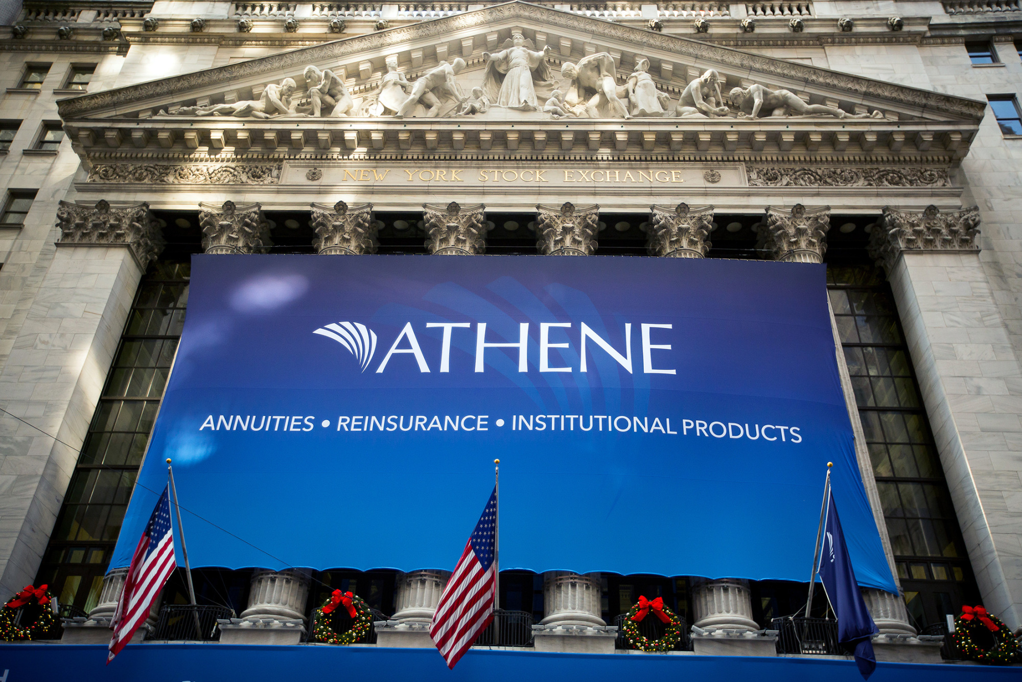 Athene Holding Ltd. signage is displayed outside of the New York Stock Exchange (NYSE) during the initial public offering of the company's stock in New York, U.S., on Friday, Dec. 9, 2016. U.S. stocks were set for a record as oil powered above $51 a barrel on signs producers are following through with agreed production cuts. The dollar rose toward an 18-month high.
