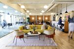 Members work in a common area at the Embarcadero WeWork Cos Inc. offices in San Francisco, California, U.S.