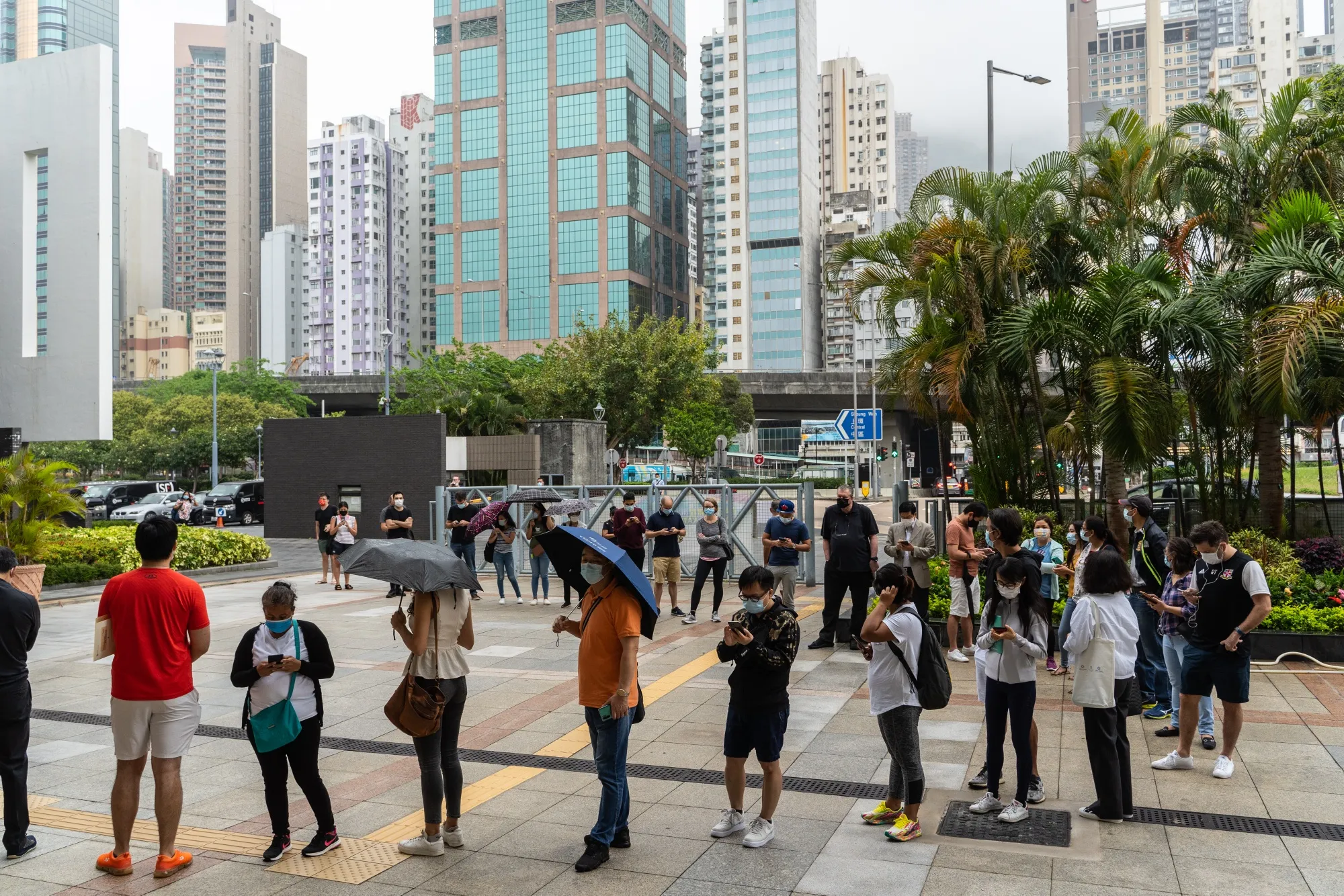 People stand in line outside a community vaccination center&nbsp;in Hong Kong.