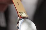 A PayChip removable contactless payment chip is shown inserted into a Mondaine luxury wristwatch.
