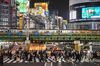 Pedestrians cross a street at night in Tokyo's Shinjuku area on April 2, 2021 as the city reported 440 new infections of the Covid-19 coronavirus. (Photo by CHARLY TRIBALLEAU / AFP) (Photo by CHARLY TRIBALLEAU/AFP via Getty Images)
