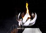 TOKYO, JAPAN - JULY 23: Naomi Osaka of Team Japan lights the Olympic cauldron with the Olympic torch during the Opening Ceremony of the Tokyo 2020 Olympic Games at Olympic Stadium on July 23, 2021 in Tokyo, Japan. (Photo by Maddie Meyer/Getty Images)