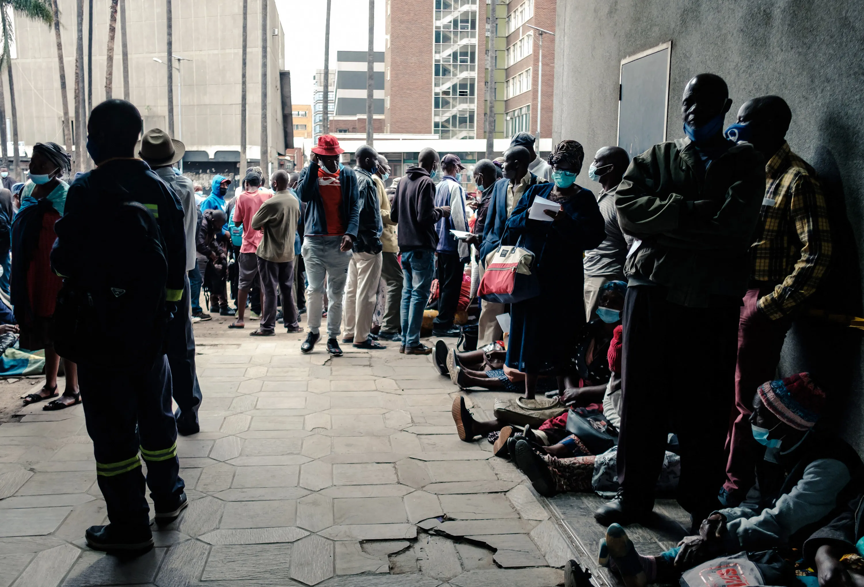 People queue for U.S. dollars at a bank early in the morning, in Harare, Zimbabwe, on Dec. 24, 2021.