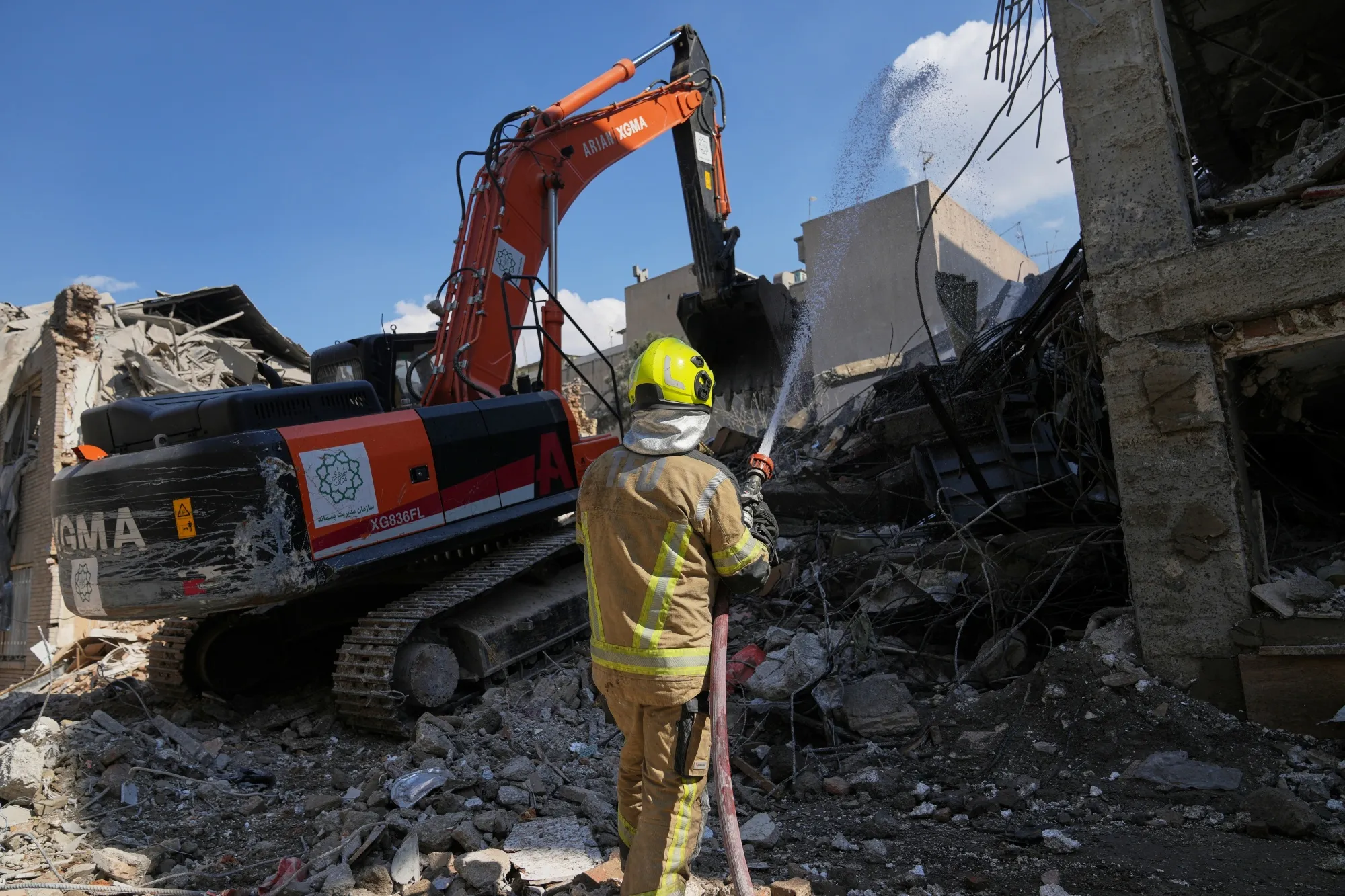 
An excavator removes rubble from the site of a strike in Tehran, on April 7.
