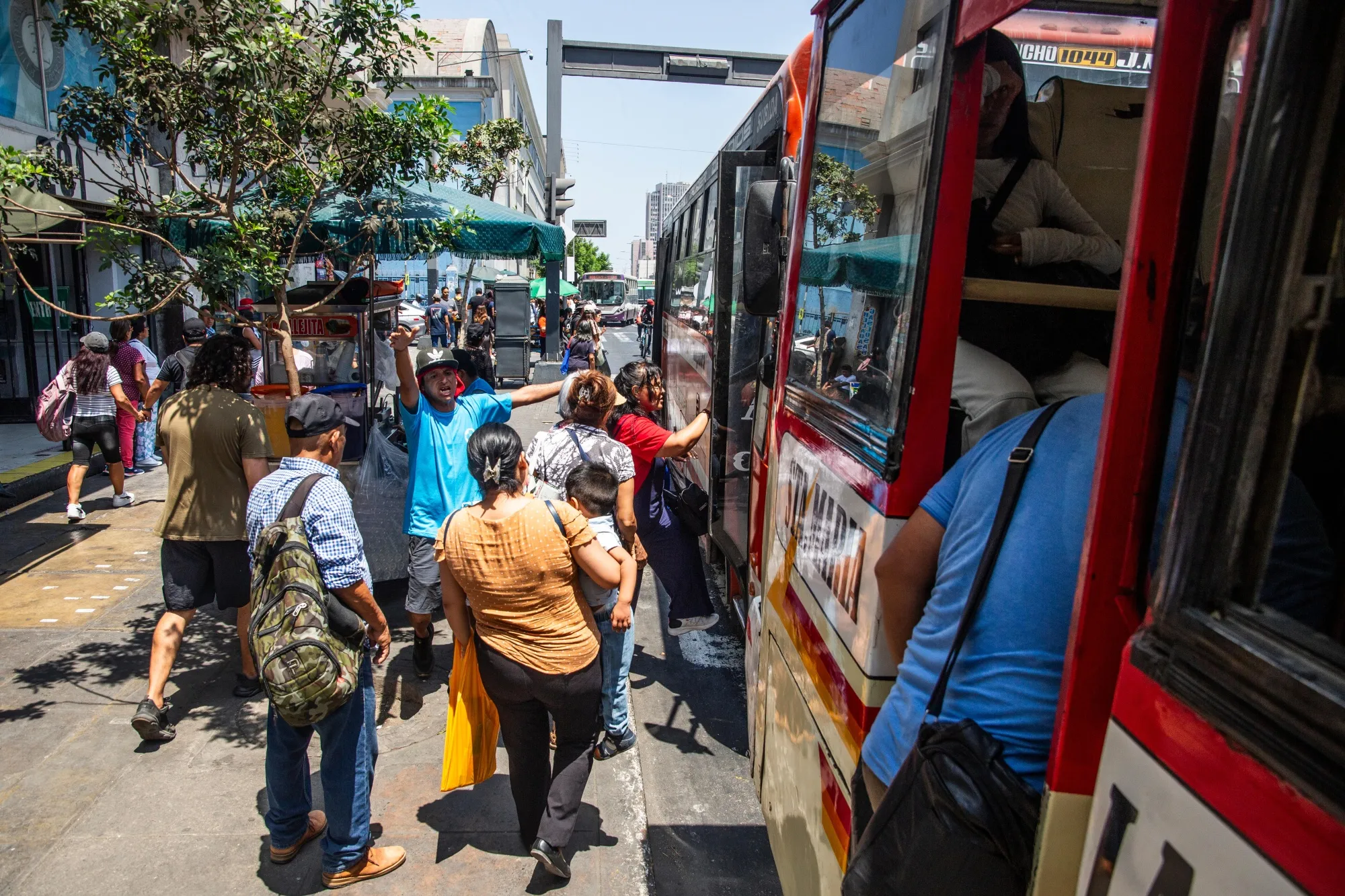 Passengers board a public bus in Lima, Peru, on March 31.