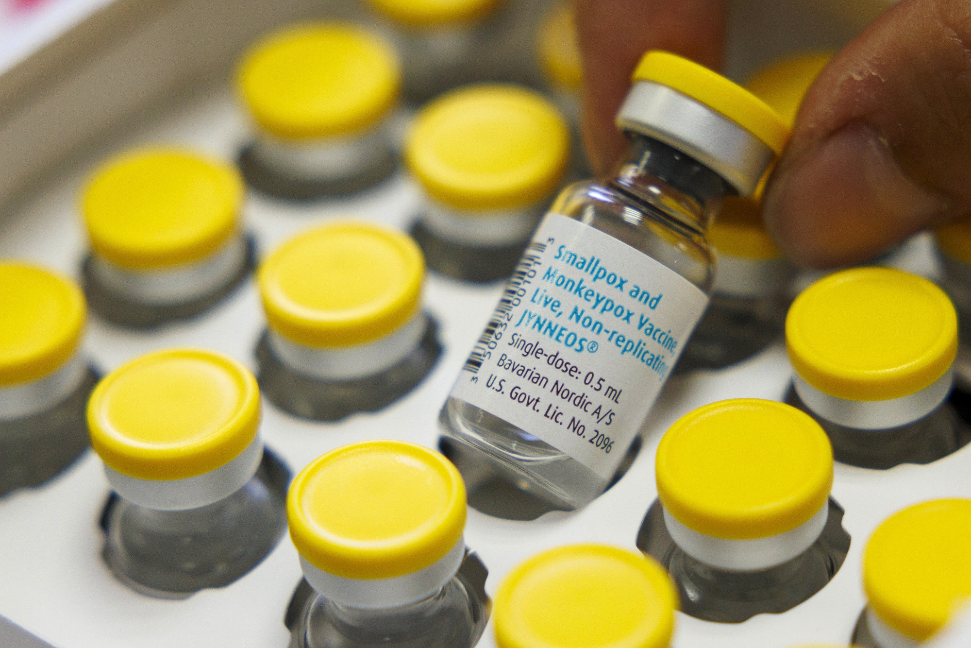 A health worker handles a vial of the Bavarian Nordic A/S Jynneos monkeypox vaccine.
