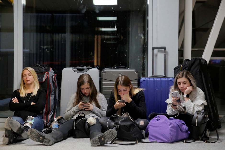 A family waits to board their flight at the John F. Kennedy International Airport in New York City.
