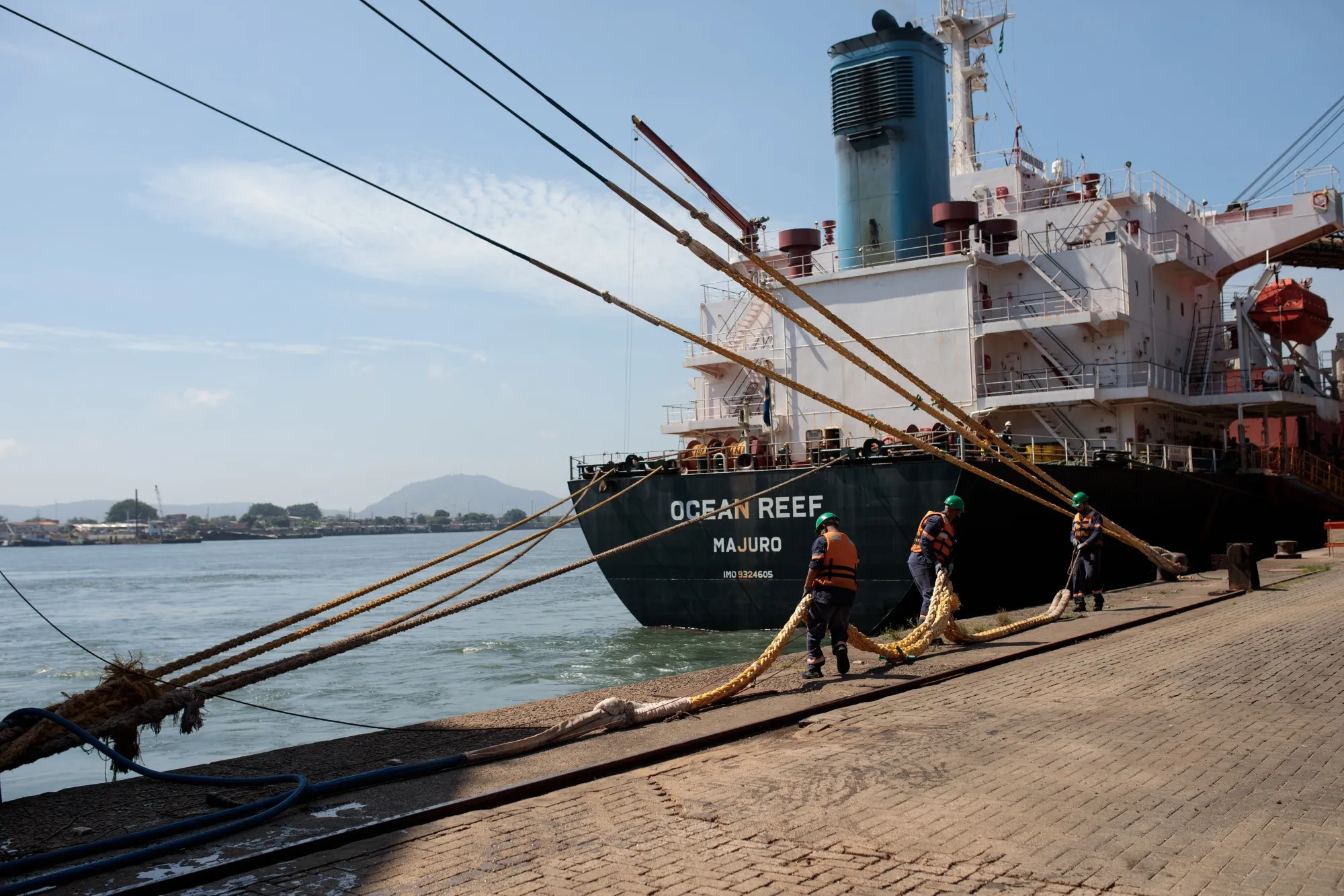Workers moor a ship at the Port of Santos in Santos, Brazil.