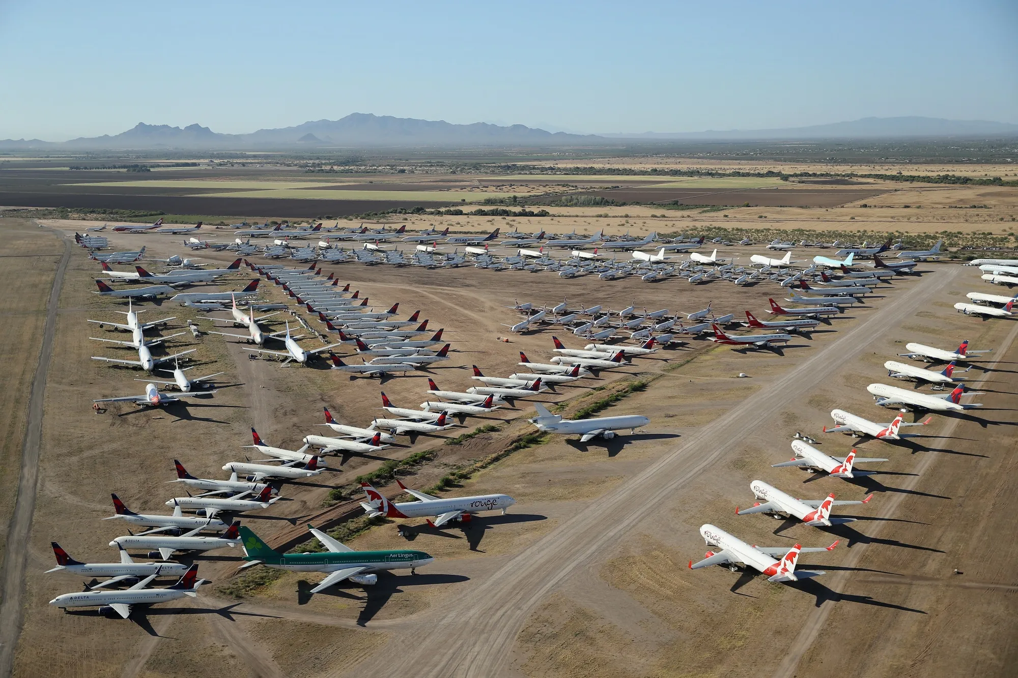 Decommissioned and suspended commercial aircraft&nbsp;at Pinal Airpark&nbsp;in Arizona in May 2020. The pandemic has brought travel to a standstill.