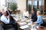 EC President Charles Michel (L), Germany's Chancellor Angela Merkel (C), France's President Emmanuel Macron (2nd R) and President of the European Commission Ursula von der Leyen during a bilateral meeting at the EU summit on a coronavirus recovery package.