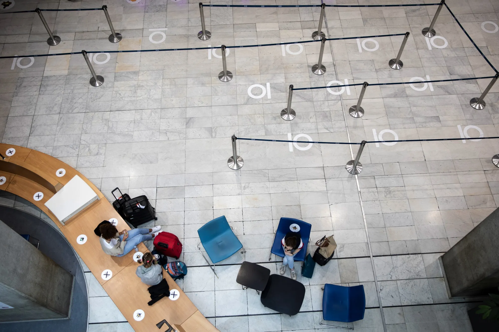 Traveler wait near social distancing guides at Charles de Gaulle Airport near Paris, on June 15.