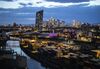 Skyscrapers stand illuminated on the financial district skyline beyond shipping containers on the quayside at Frankfurt Osthafen container dock, operated by Contargo Rhein-Neckar GmbH, in Frankfurt, Germany, on Tuesday, Aug. 13. 2019. Germany’s economy shrank in the second quarter, ramping up pressure on Chancellor Angela Merkel to unleash fiscal stimulus as manufacturers reel from a U.S.-China trade war.