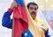 Venezuelan President Nicolas Maduro holds a flag during a demonstration against the United States' decision to renew sanctions on several top Venezuelan officials, in Caracas on March 12, 2016.