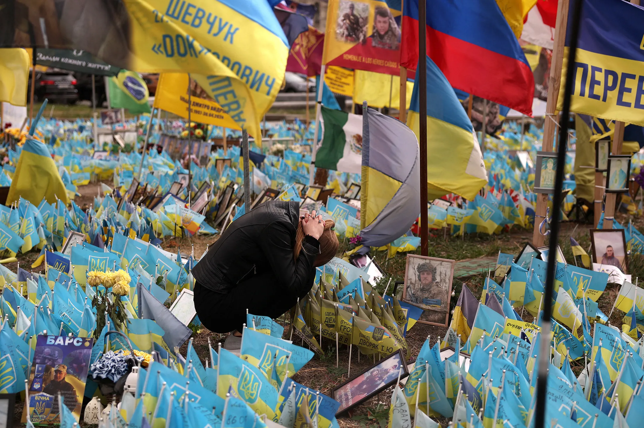 A woman grieves at a makeshift memorial for fallen Ukrainian soldiers at the Independence Square in Kyiv, on Sept.&nbsp;30.