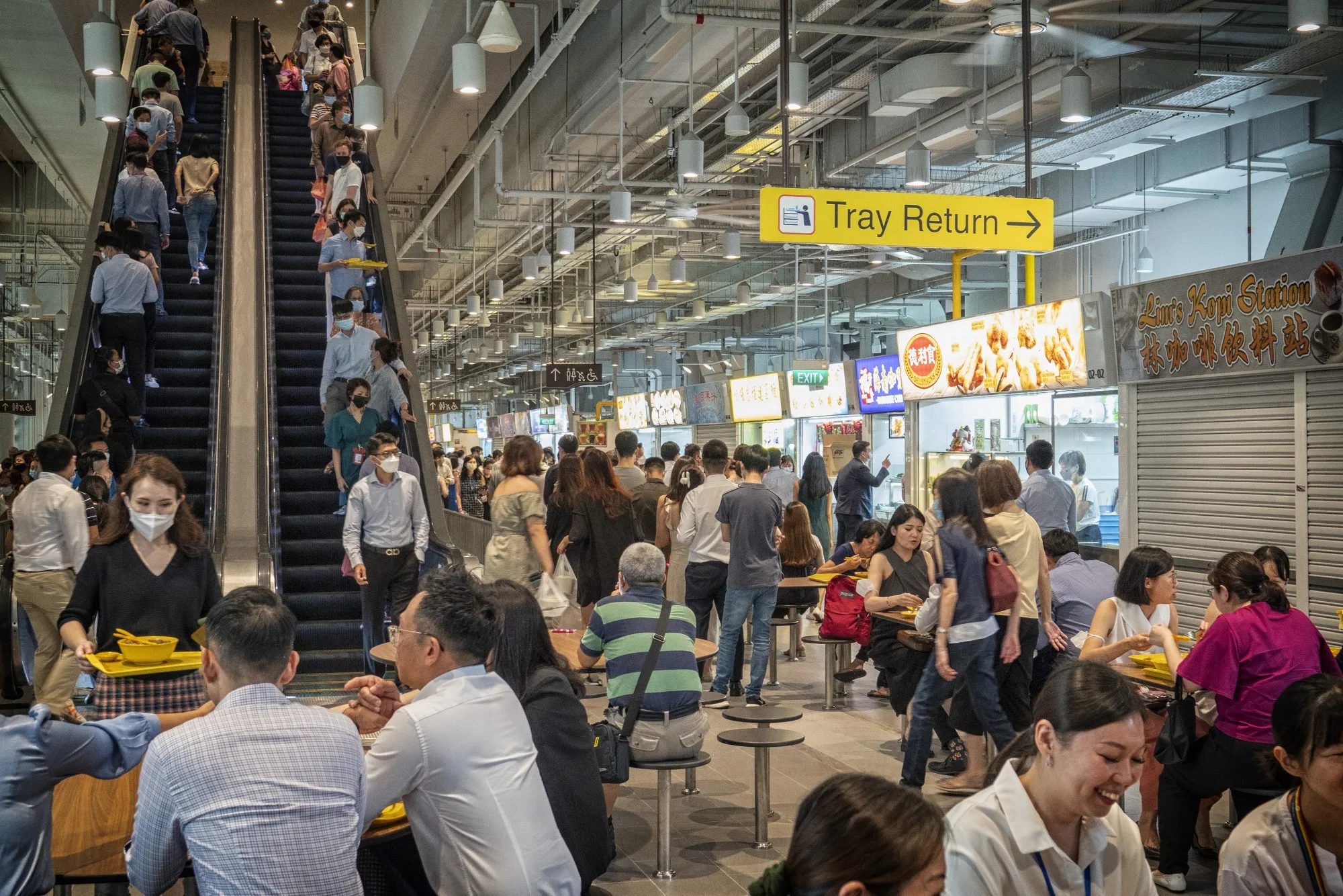 Customers at the Market Street Hawker Centre during lunch hour in Singapore.