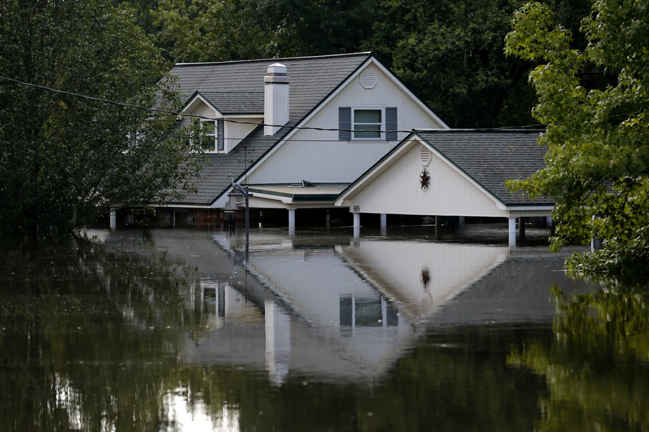 A house partly submerged by flood waters from Tropical Storm Harvey in Rose City, Texas