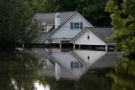 A house partly submerged by flood waters from Tropical Storm Harvey in Rose City, Texas