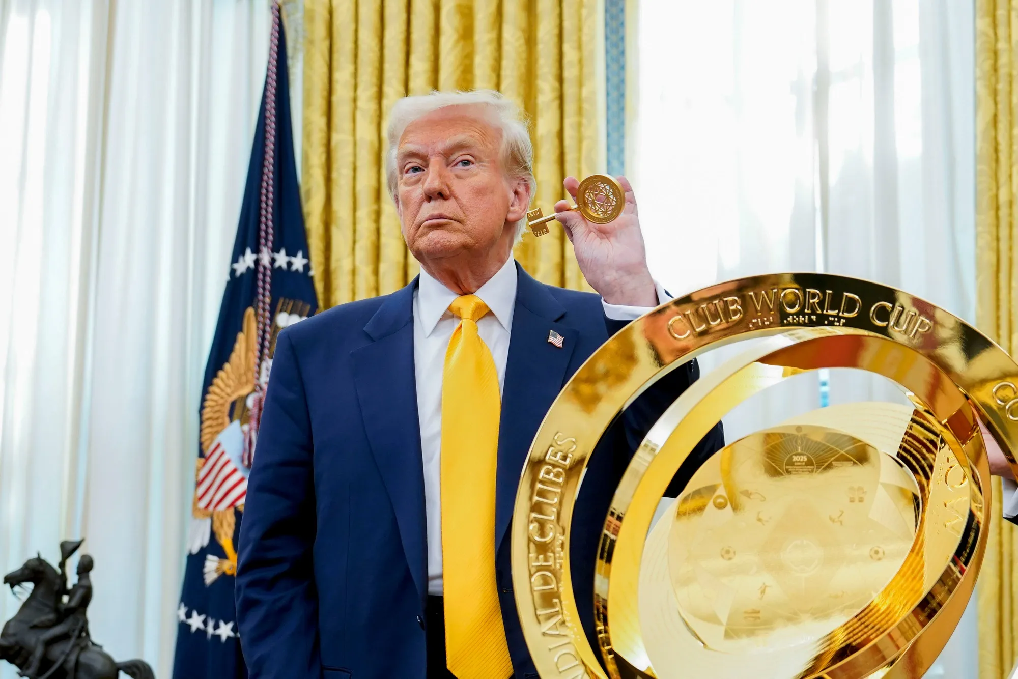 US President Donald Trump with the World Cup trophy during an executive order signing in the Oval Office of the White House in Washington, DC, US, on Friday, March 7, 2025.&nbsp;