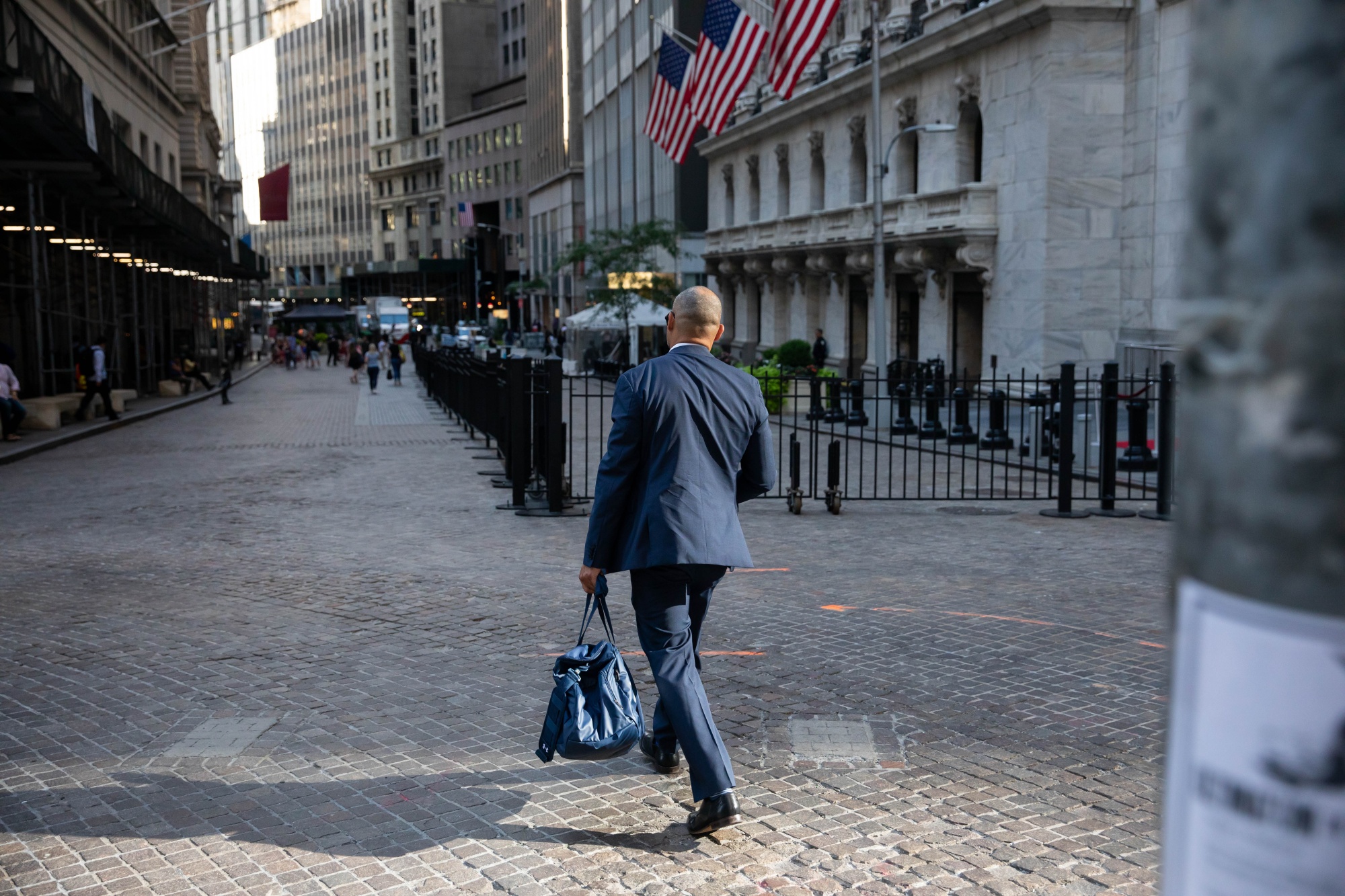 A pedestrian passes in front of the New York Stock Exchange (NYSE) in New York.