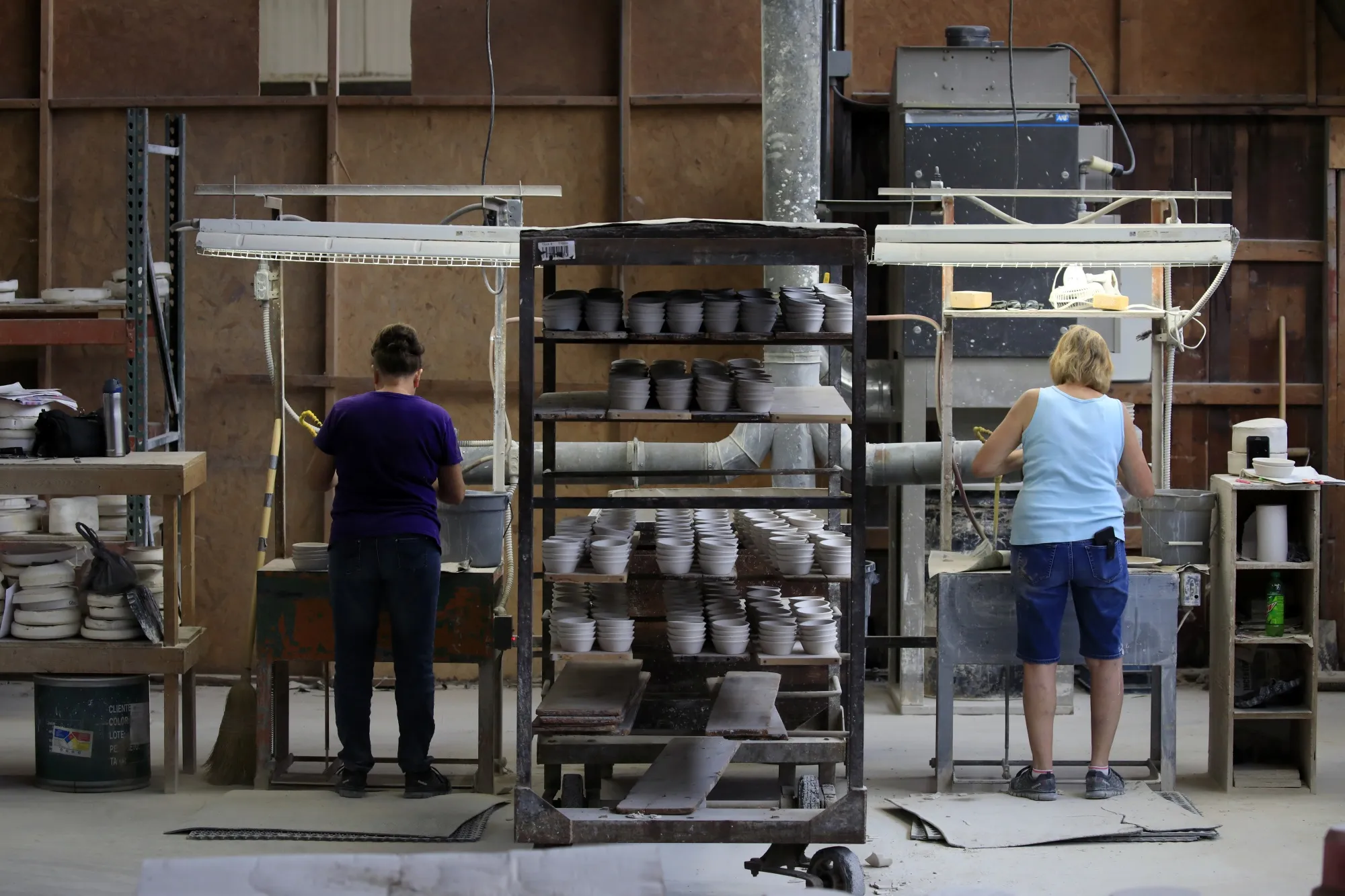 Workers manufacture dinnerware at a factory in Newell, West Virginia.