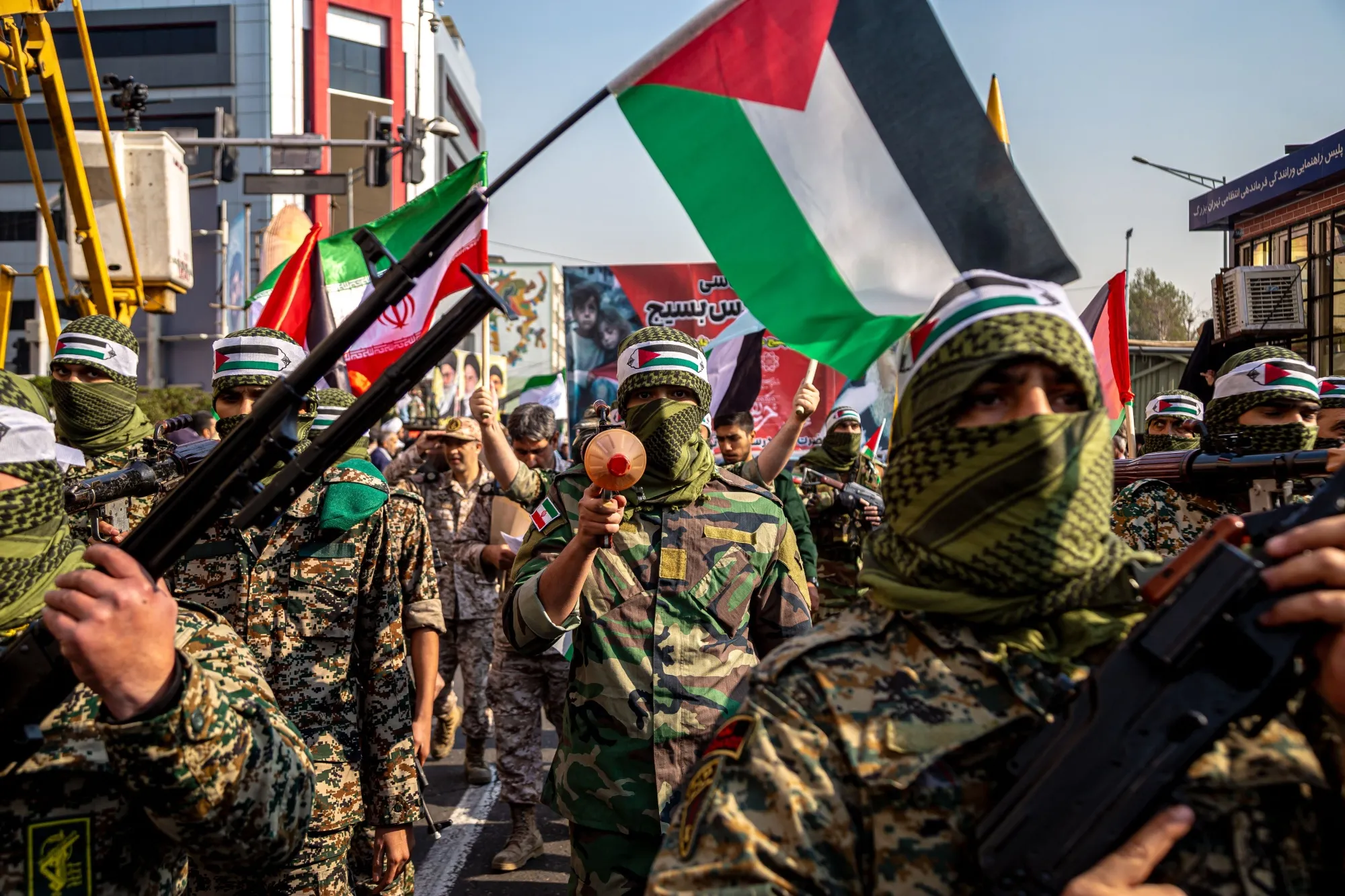 Members of the Islamic Revolutionary Guard wear Palestinian scarves at a rally in Tehran.