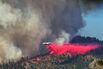 A plane drops fire retardant as the Washburn Fire burns near the Mariposa Grove of giant sequoias and the south entrance of Yosemite National Park on July 11, 2022.