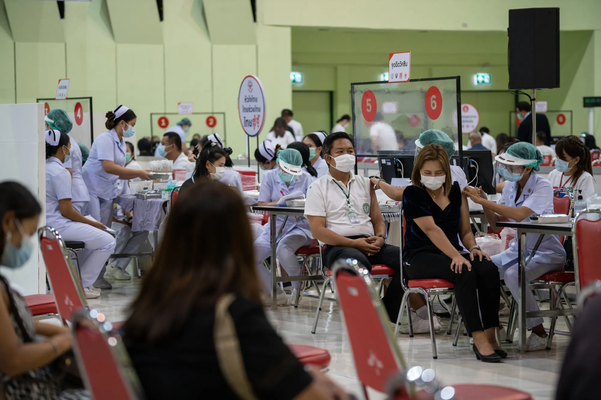 People receive a dose of Covid-19 vaccine at a vaccination center at the Mall Bangkapi shopping mall in Bangkok, on May 14.