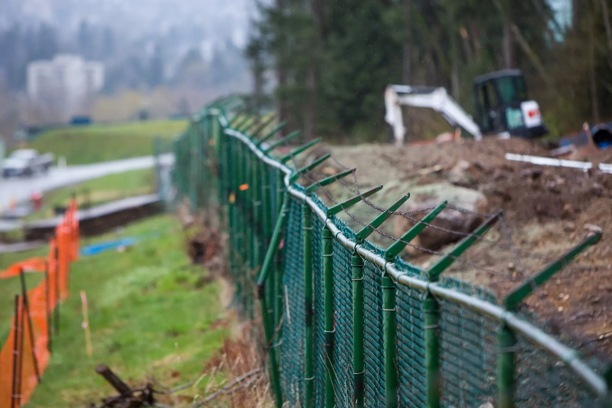 Barbed wire fencing stands at the Trans Mountain pipeline expansion site in Burnaby, Canada, in 2018.