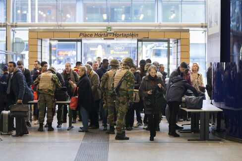 Soldiers check baggage at Brussels Midi train station.