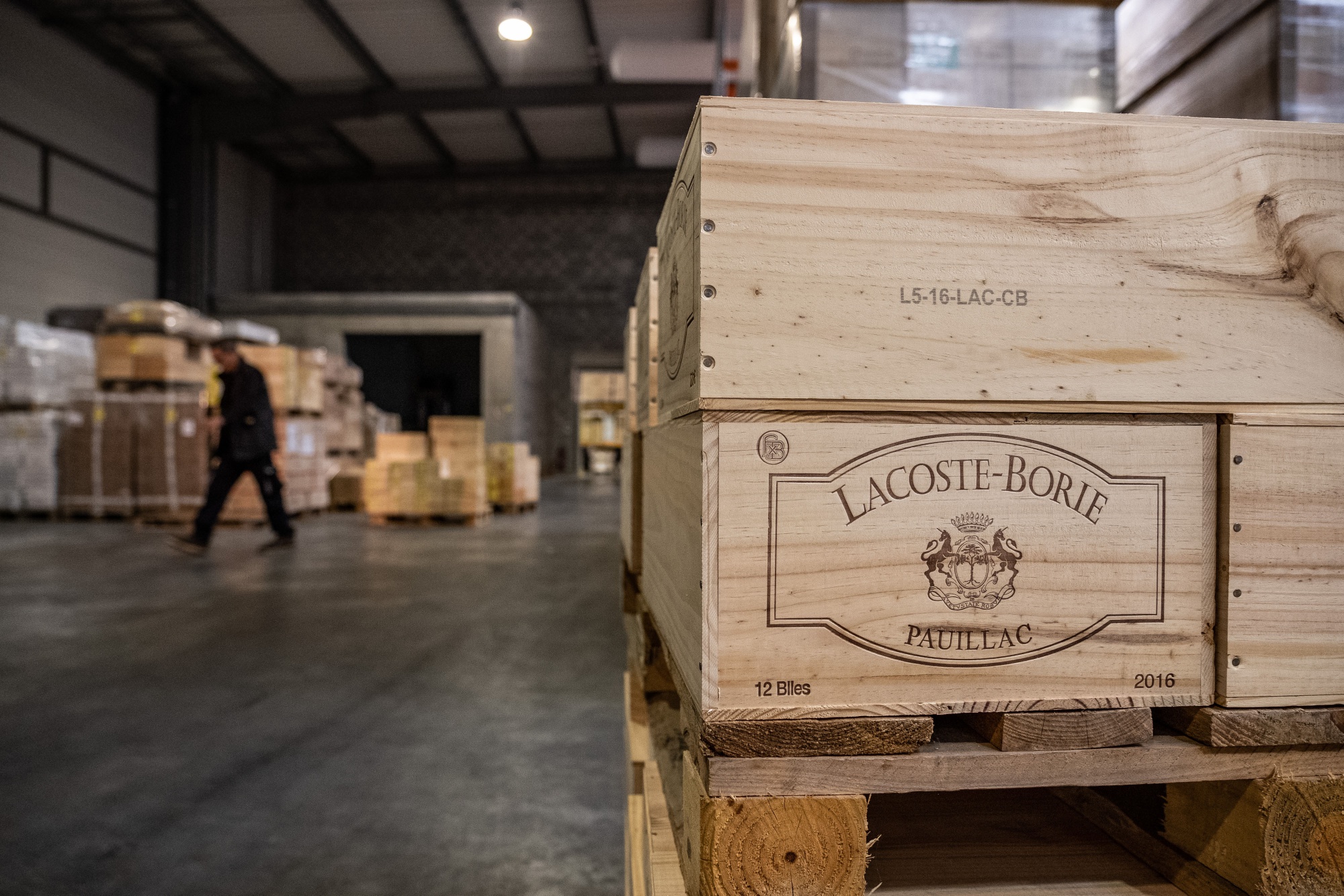 Wooden boxes of Lacoste-Borie Pauillac red wine sit on a pallet inside a JF Hillebrand Group AG wine storage and transit logistics warehouse in Blanquefort, France, on Friday, Sept. 27, 2019. The U.S. is moving ahead with an investigation into a new French digital tax that could lead to import tariffs on French wine and other goods, despite hopes raised at August's G-7 summit. Photographer: Balint Porneczi/Bloomberg