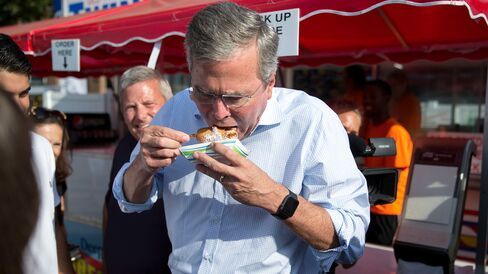 Republican presidential candidate Jeb Bush eats a deep-fried Snickers bar as he tours the Iowa State Fair in Des Moines on Aug. 14, 2015.