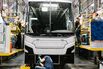 Workers assemble a bus at a factory in Sainte-Claire, Quebec, Canada.
